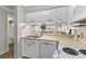 Clean kitchen featuring white cabinetry and a stainless steel sink at 824 N Waccamaw Dr. # 203, Murrells Inlet, SC 29576