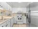 Efficient kitchen with white cabinets, stainless steel refrigerator and essential appliances at 824 N Waccamaw Dr. # 203, Murrells Inlet, SC 29576