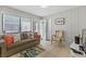 Living room features wood paneling, tile floors, couch, chair and coastal decorations at 824 N Waccamaw Dr. # 203, Murrells Inlet, SC 29576