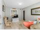 Living room features tiled floors, neutral colored walls, comfortable chair, and a window at 824 N Waccamaw Dr. # 203, Murrells Inlet, SC 29576