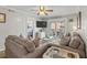 Living room features neutral decor, sliding door access to balcony, and comfortable seating area at 824 N Waccamaw Dr. # 203, Murrells Inlet, SC 29576