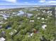 Beautiful aerial view of home nestled amongst trees with views of the coastline and waterway in the background at 88 Salt Marsh Circle # 22F, Pawleys Island, SC 29585