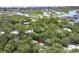 A lovely aerial view of a home amongst trees with waterway views in the background on a bright, sunny day at 88 Salt Marsh Circle # 22F, Pawleys Island, SC 29585