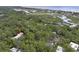 An aerial view of a condo nestled amongst trees with views of the marsh and the coast in the distance at 88 Salt Marsh Circle # 22F, Pawleys Island, SC 29585