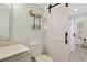 Well-designed bathroom with a sliding barn door leading to the tiled shower for a clean and modern aesthetic at 88 Salt Marsh Circle # 22F, Pawleys Island, SC 29585