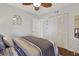 Cozy bedroom featuring stylish bedding, wood floors, and a mirrored wall decoration above the bed at 88 Salt Marsh Circle # 22F, Pawleys Island, SC 29585