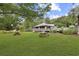 Community building featuring a deck, pond view, and well-manicured lawn at 88 Salt Marsh Circle # 22F, Pawleys Island, SC 29585