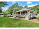 Exterior of community clubhouse with outdoor seating, pond view, and landscaping at 88 Salt Marsh Circle # 22F, Pawleys Island, SC 29585
