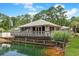 Community building featuring a deck, pond view, and well-manicured lawn at 88 Salt Marsh Circle # 22F, Pawleys Island, SC 29585