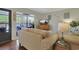 Welcoming living room with hardwood floors and comfortable seating area that transitions to an outdoor patio at 88 Salt Marsh Circle # 22F, Pawleys Island, SC 29585