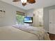 Bright main bedroom with wood floors showcases a coastal theme with a TV for entertainment and a view of outside at 88 Salt Marsh Circle # 22F, Pawleys Island, SC 29585