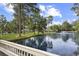 Scenic pond with lush foliage and community buildings in the background at 88 Salt Marsh Circle # 22F, Pawleys Island, SC 29585