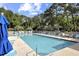 Community swimming pool with seating, landscaping, and views of surrounding foliage at 88 Salt Marsh Circle # 22F, Pawleys Island, SC 29585