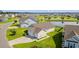 Aerial view of home with two-car garage, landscaping, and serene pond nearby at 915 Sorano St., Myrtle Beach, SC 29579