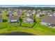 Serene aerial shot of a home with a fenced yard near a pond, nestled in a tranquil community at 915 Sorano St., Myrtle Beach, SC 29579