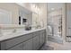 Bright bathroom featuring a double sink vanity, large mirror, and glass enclosed shower at 915 Sorano St., Myrtle Beach, SC 29579