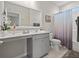 Stylish bathroom with vanity, large mirror, gray cabinets, and tub shower with curtain at 915 Sorano St., Myrtle Beach, SC 29579