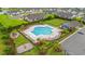 Resort-style community pool with ample seating, lush landscaping, and a nearby playground at 915 Sorano St., Myrtle Beach, SC 29579