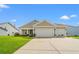 Charming tan home with a two car garage, manicured lawn, and beautiful landscaping at 915 Sorano St., Myrtle Beach, SC 29579