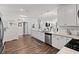 Spacious kitchen boasts white cabinets, quartz countertops, and stainless steel appliances at 915 Sorano St., Myrtle Beach, SC 29579