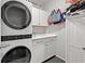 Modern laundry room with front loading washer and dryer and white shaker cabinets at 915 Sorano St., Myrtle Beach, SC 29579