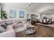 Open-concept living room with hardwood floors, ceiling fan, and seamless flow to dining area at 915 Sorano St., Myrtle Beach, SC 29579