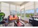 Bright sunroom with lots of windows, comfortable seating, and a view of the outdoors at 915 Sorano St., Myrtle Beach, SC 29579