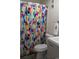 Bathroom with a colorful shower curtain, neutral cabinets and white fixtures at 9571 Shore Dr. # 318, Myrtle Beach, SC 29572