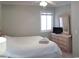 Serene bedroom featuring a queen bed, dresser with a TV, and neutral decor at 9571 Shore Dr. # 318, Myrtle Beach, SC 29572
