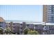 A partial water view is visible beyond the condo buildings and palm trees at 9571 Shore Dr. # 318, Myrtle Beach, SC 29572