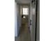 Hallway showcasing the entry to a bedroom with a sliding white barn door at 9571 Shore Dr. # 318, Myrtle Beach, SC 29572