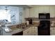 Well-equipped condo kitchen with granite countertops, black appliances, and a convenient breakfast bar at 9571 Shore Dr. # 318, Myrtle Beach, SC 29572