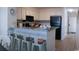 Bright kitchen features granite countertops, modern appliances, and breakfast bar with seating at 9571 Shore Dr. # 318, Myrtle Beach, SC 29572