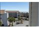 A landscaped parking lot with multiple buildings, palm trees and a view of the ocean at 9571 Shore Dr. # 318, Myrtle Beach, SC 29572