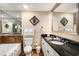 Bathroom with double sinks, granite countertops, large mirror, and tiled tub-shower combination at 100 North Beach Blvd. # 710, North Myrtle Beach, SC 29582
