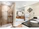 Updated bathroom featuring tiled walk-in shower, bathtub, double sinks, and granite countertops at 100 North Beach Blvd. # 710, North Myrtle Beach, SC 29582