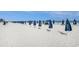 Sunny beach scene with blue umbrellas lined up along the sandy shore near the ocean at 100 North Beach Blvd. # 710, North Myrtle Beach, SC 29582