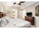 Cozy bedroom includes a ceiling fan, neutral-toned walls, a dresser, and an open ensuite bathroom at 100 North Beach Blvd. # 710, North Myrtle Beach, SC 29582