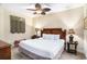Comfortable bedroom featuring a ceiling fan, lamps and a plush bed with soft, neutral bedding at 100 North Beach Blvd. # 710, North Myrtle Beach, SC 29582