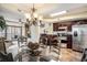 Bright dining area with a glass-top table, a chandelier, and a view into the kitchen at 100 North Beach Blvd. # 710, North Myrtle Beach, SC 29582