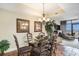 Open dining area with a glass table, chandelier, and a glimpse of the ocean view at 100 North Beach Blvd. # 710, North Myrtle Beach, SC 29582