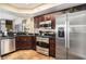 Well-lit kitchen featuring stainless steel appliances, dark wood cabinetry, and granite countertops at 100 North Beach Blvd. # 710, North Myrtle Beach, SC 29582