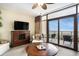 Cozy living room with a ceiling fan, TV, and sliding glass doors to a balcony with an ocean view at 100 North Beach Blvd. # 710, North Myrtle Beach, SC 29582
