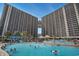 Outdoor pool area that includes room to swim, a swim-up bar, a slide, and lounge seating at 100 North Beach Blvd. # 710, North Myrtle Beach, SC 29582