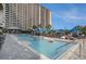 Large outdoor pool for residents with lounge seating, umbrellas, and sundeck for enjoyment at 100 North Beach Blvd. # 710, North Myrtle Beach, SC 29582