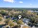 Aerial view of a house situated among tall trees in a well-populated neighborhood at 1044 Martin Ln., Conway, SC 29526
