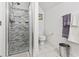 Modern bathroom features tiled shower with glass door and gray tile, plus white tile floors and a white toilet at 1044 Martin Ln., Conway, SC 29526