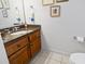 Powder room featuring a wood cabinet with granite countertops, and tiled floors at 1044 Martin Ln., Conway, SC 29526