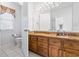 Bathroom features a wood cabinet with granite countertops, tiled floors, and an ample mirror at 1044 Martin Ln., Conway, SC 29526