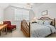 Well-lit bedroom featuring a ceiling fan, neutral carpet, and a wooden bed frame at 1044 Martin Ln., Conway, SC 29526